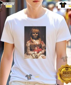 Alt Text: Top The Conjuring Last Rites Annabelle T-Shirt featuring eerie graphic design, perfect for horror movie fans.