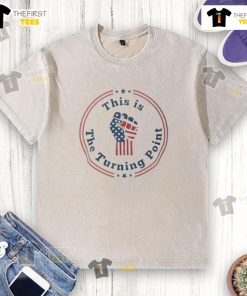 Charlie Kirk fist raised in front of a US flag on a washed t-shirt, symbolizing patriotism and activism. Shop now!