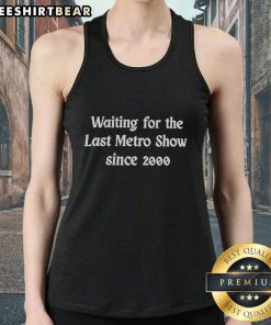 Person wearing 'Top-Waiting-For-The-Last-Metro-Show-Since-2000' tank top, showcasing unique graphic design in urban setting.