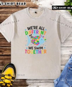 Alt Text: Colorful fish design on washed t-shirt with the phrase 'We're All Different, But In This Class, We Swim Together'.