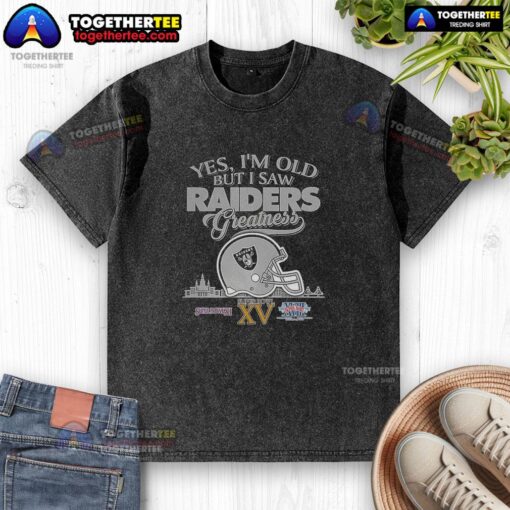 Alt Text: Oakland Raiders Super Bowl helmet graphic on a washed t-shirt, featuring skyline design and 'Top-Yes-Im-Old-But-I-Greatness' text.