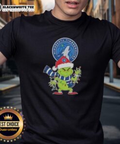 Awesome 2025 Minnesota Timberwolves Christmas Grinch Santa Hat Holiday T-Shirt featuring festive graphics and team colors.