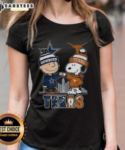 Alt Text: Ladies tee featuring Charlie Brown and Snoopy with Dallas Cowboys and Texas Longhorns skyline design.