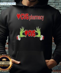 Awesome Grinch hands holding a CVS Pharmacy Christmas hoodie, perfect for holiday cheer and festive celebrations.
