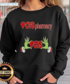 Awesome Grinch hands on a festive Christmas sweatshirt from CVS Pharmacy, perfect for holiday celebrations.
