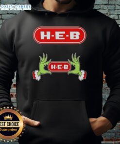 Awesome Grinch hands holding a heart on a cozy H-E-B Christmas hoodie, perfect for festive holiday cheer.