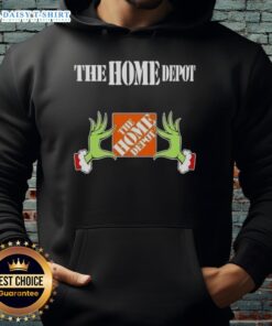 Awesome Grinch hands holding The Home Depot Christmas hoodie, perfect for festive holiday celebrations and gift giving.