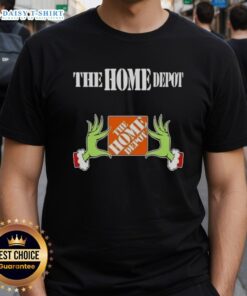 Awesome Grinch hands holding a Christmas ornament on a Home Depot T-Shirt, perfect for holiday festivities and gifts.