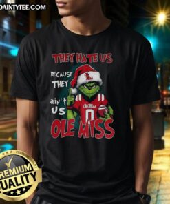 Awesome Grinch Ole Miss Rebels football t-shirt with 'They Hate Us Because They Ain't Us' slogan in vibrant design.