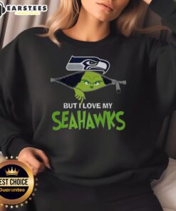 Alt Text: Awesome Grinch sweatshirt featuring 'I Hate People But I Love My Seattle Seahawks' for Christmas football fans.