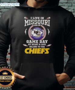 Person wearing a Kansas City Chiefs hoodie, showcasing team spirit in Missouri on game day.