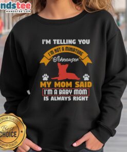 Funny baby wearing a sweatshirt saying 'I'm Not A Miniature Schnauzer' with playful expression, showcasing pet humor.