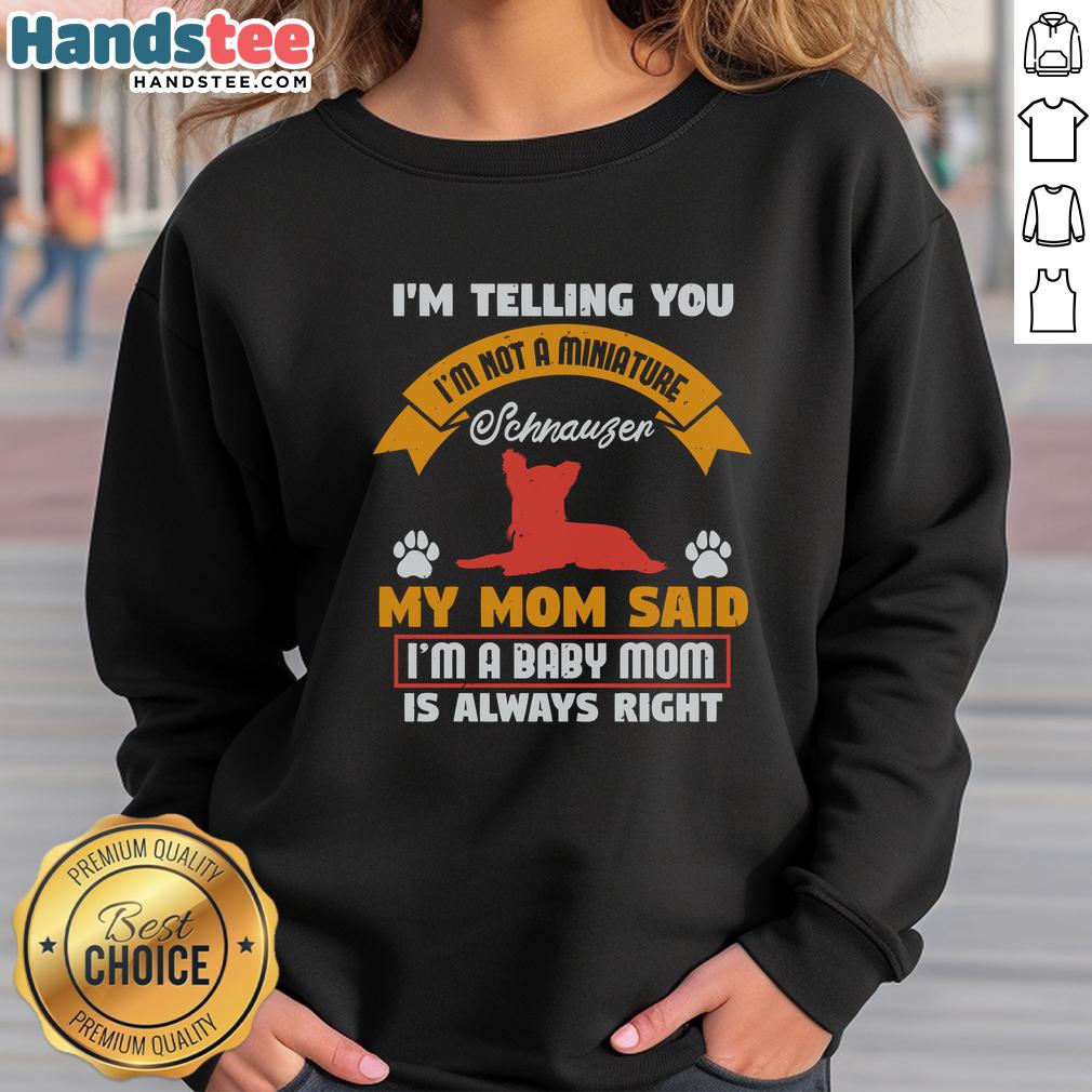 awesome-im-telling-you-im-not-a-miniature-schnauzer-my-mom-said-im-a-baby-mom-sweatshirt Funny baby wearing a sweatshirt saying 'I'm Not A Miniature Schnauzer' with playful expression, showcasing pet humor.