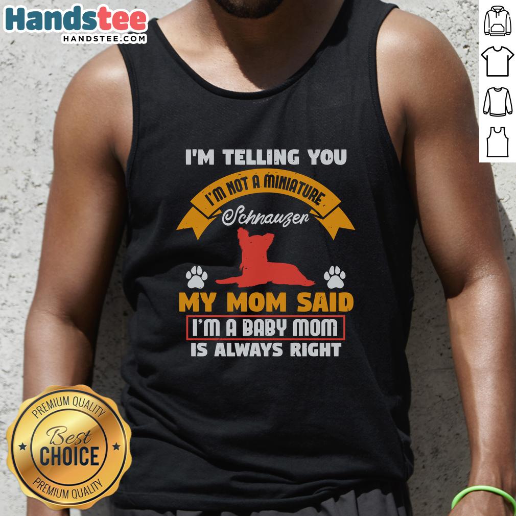 awesome-im-telling-you-im-not-a-miniature-schnauzer-my-mom-said-im-a-baby-mom-tank-top Adorable puppy wearing a tank top that says 'I'm Not A Miniature Schnauzer' showcasing its playful personality.