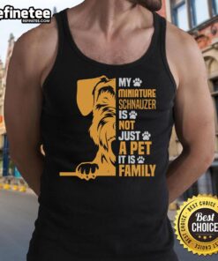 Miniature Schnauzer wearing a tank top with 'Not Just a Pet, It's Family' slogan, showcasing love for pets.