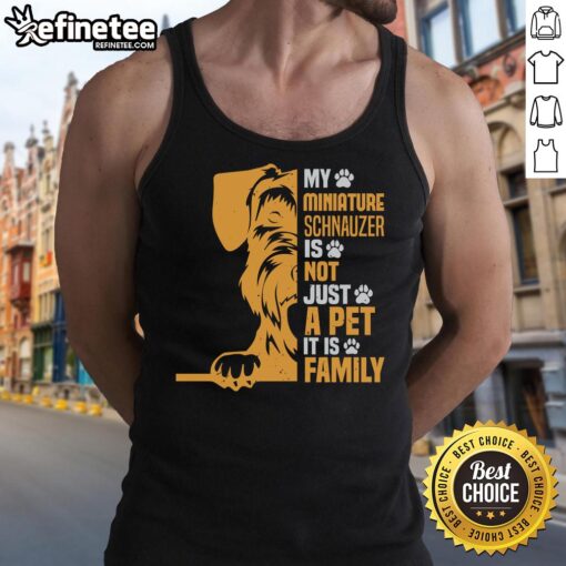 Miniature Schnauzer wearing a tank top with 'Not Just a Pet, It's Family' slogan, showcasing love for pets.