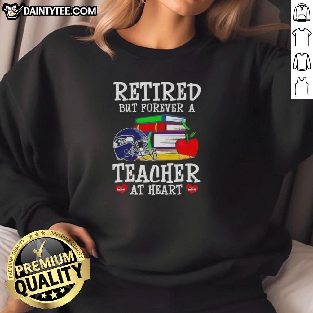 awesome-retired-but-forever-a-teacher-at-heart-seattle-seahawks-football-sweatshirt Awesome retired but forever a teacher at heart Seattle Seahawks football sweatshirt displayed on a hanger.