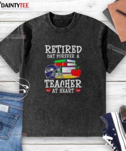 Awesome retired but forever a teacher at heart Seattle Seahawks football washed t-shirt displayed on a hanger.
