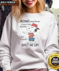 Awesome Snoopy sweatshirt featuring a fun aging quote: 'May have slowed me down, but hasn't shut me up.'
