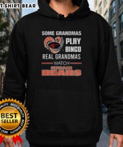 Grandmas play bingo in cozy hoodies while watching Chicago Bears football, showcasing fun and warmth in stylish apparel.