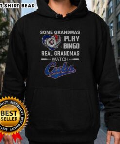 Grandmas enjoying bingo while wearing a 'Real Grandmas Watch Cubs' hoodie, showcasing their love for Chicago Cubs baseball.