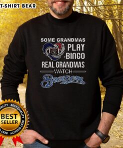 Grandmas enjoying Bingo in Milwaukee, wearing 'Real Grandmas Watch Brewers Baseball' sweatshirts, celebrating fun times.