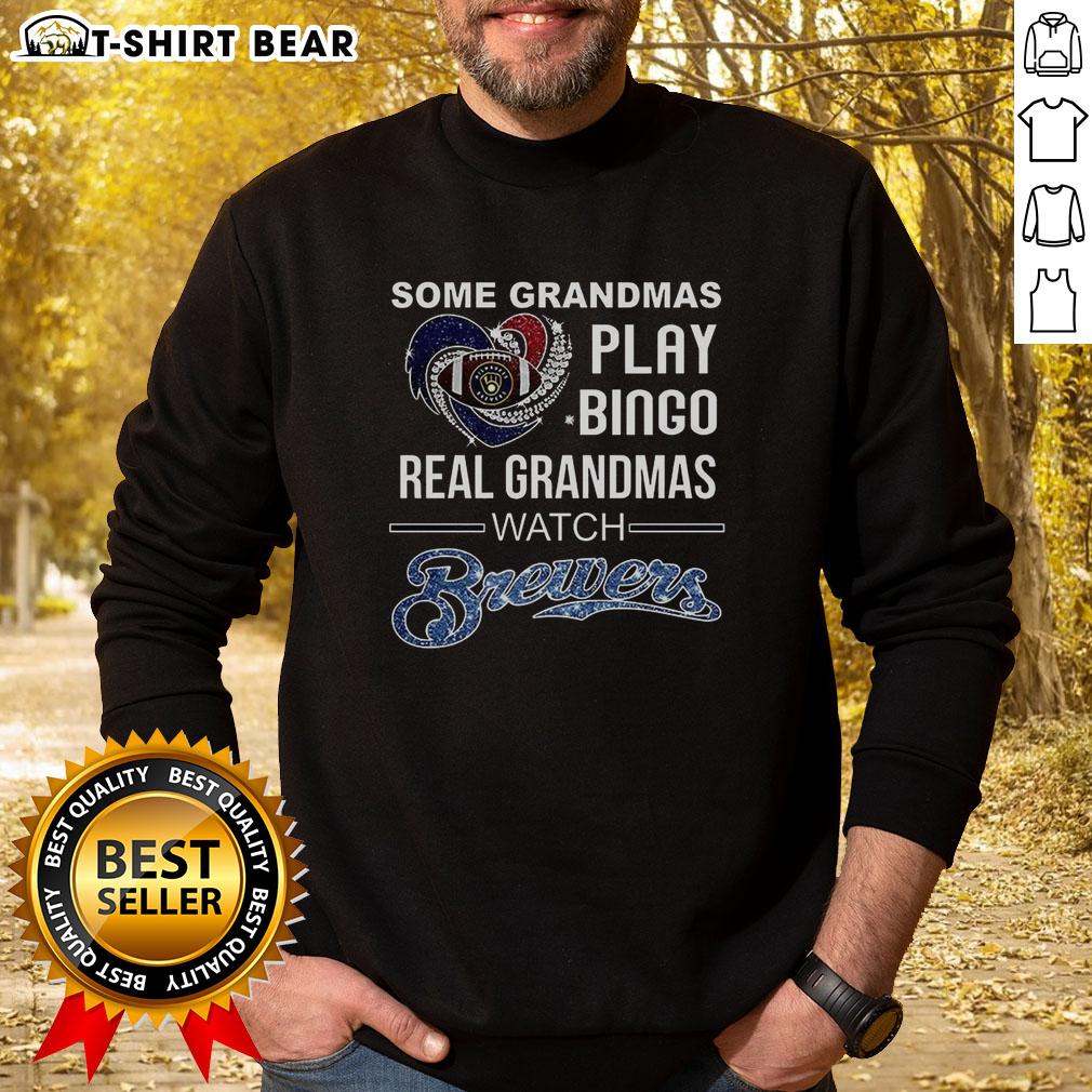 Awesome Some Grandmas Play Bingo Real Grandmas Watch Milwaukee Brewers Baseball Diamond Heart Sweatshirt Grandmas enjoying Bingo in Milwaukee, wearing 'Real Grandmas Watch Brewers Baseball' sweatshirts, celebrating fun times.