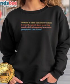 Awesome Tell Me A Time In History sweatshirt featuring a graphic of masked figures, perfect for history enthusiasts.
