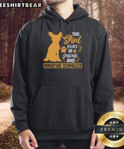 Girl wearing 'This Girl Runs on Jesus and Miniature Schnauzer' hoodie, smiling with her Miniature Schnauzer.