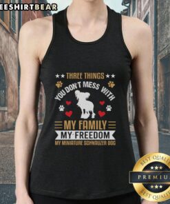 Alt Text: Awesome tank top featuring 'Three Things You Don't Mess With: My Family, My Freedom, My Miniature Schnauzer' design.