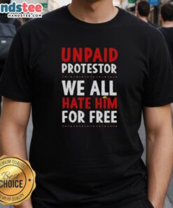 Unpaid protestor wearing a 'Free Trump' hair t-shirt, showcasing a bold statement in a crowded rally setting.