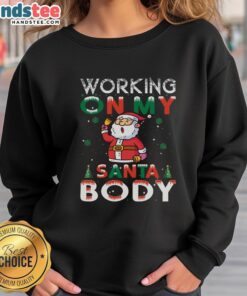 Person wearing an 'Awesome Working On My Santa Body' sweatshirt, showcasing holiday spirit and festive style.