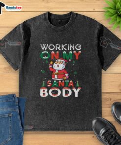 Person wearing an 'Awesome Working on My Santa Body' washed t-shirt, showcasing holiday spirit and casual style.