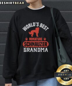 Cute Grandma wearing an Awesome World's Best Miniature Schnauzer sweatshirt, showcasing her love for the breed.