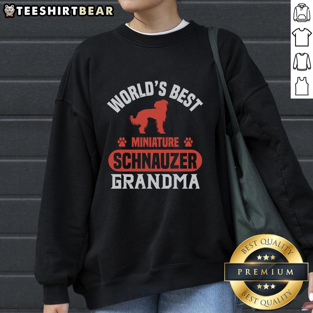 Awesome World'S Best Miniature Schnauzer Grandma Sweatshirt Cute Grandma wearing an Awesome World's Best Miniature Schnauzer sweatshirt, showcasing her love for the breed.