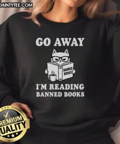 Alt Text: Adorable cat wearing a 'Go Away I'm Reading Banned Books' sweatshirt, perfect for book lovers and cat enthusiasts.