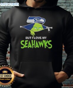 Alt Text: Adorable Grinch wearing a Seattle Seahawks football hoodie, showcasing team spirit and festive cheer.