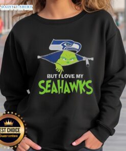 Adorable Grinch wearing a Seattle Seahawks sweatshirt, showcasing team spirit and holiday cheer.