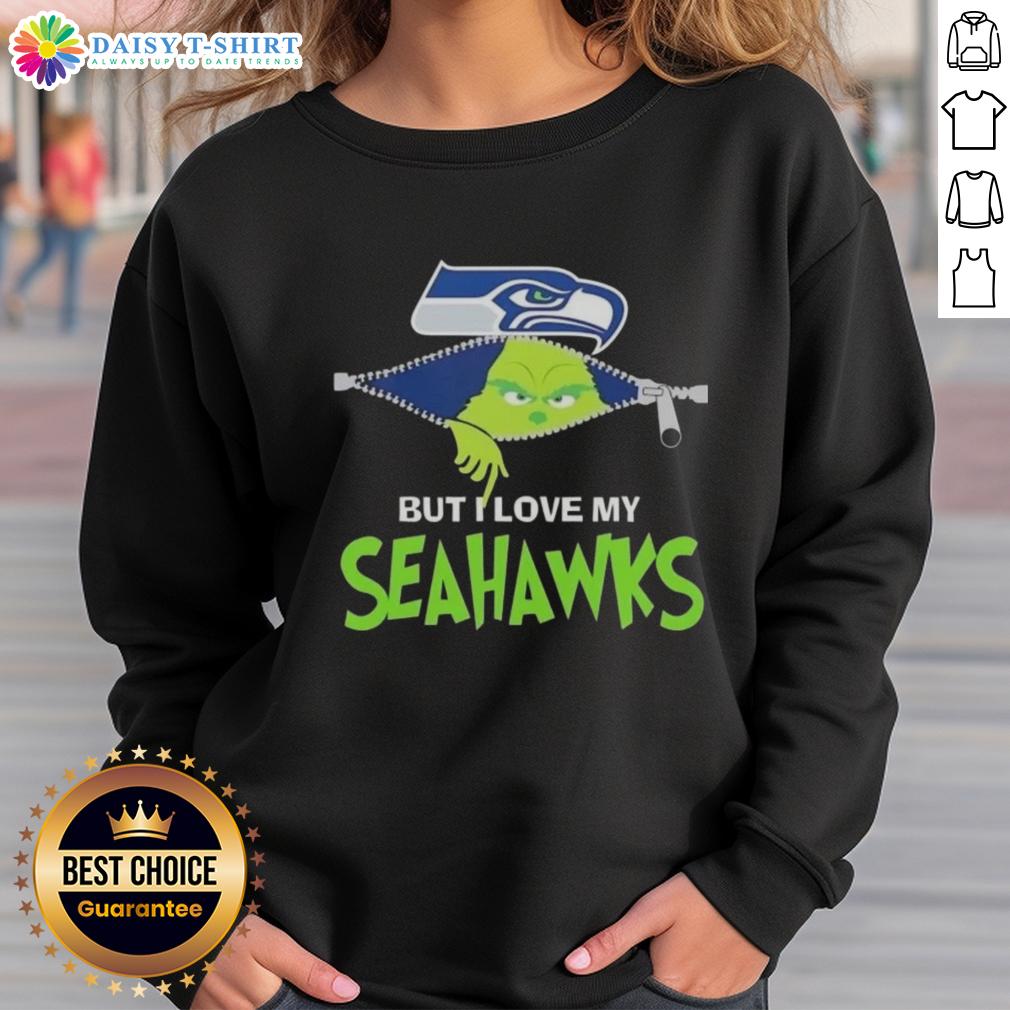 Cute Grinch But I Love My Seattle Seahawks Football Sweatshirt Adorable Grinch wearing a Seattle Seahawks sweatshirt, showcasing team spirit and holiday cheer.
