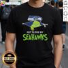 Alt Text: Cute Grinch wearing a Seattle Seahawks football T-shirt, showcasing team spirit and holiday cheer in a playful design.