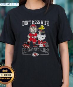 Alt Text: Cute Snoopy and Charlie Brown Peanuts graphic on a ladies tee, celebrating Kansas City Chiefs football spirit.