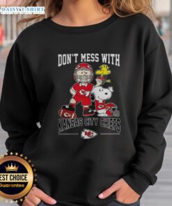 Alt Text: Cute Snoopy and Charlie Brown Peanuts sweatshirt featuring Don't Mess With Kansas City Chiefs football design.