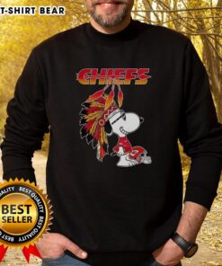 Alt Text: Cute Snoopy in war bonnets on a Kansas City Chiefs football helmet sweatshirt design, perfect for NFL fans.
