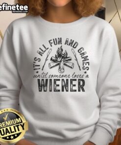Funny camping sweatshirt reading 'All fun and games until someone loses a weiner' for outdoor enthusiasts and humor lovers.