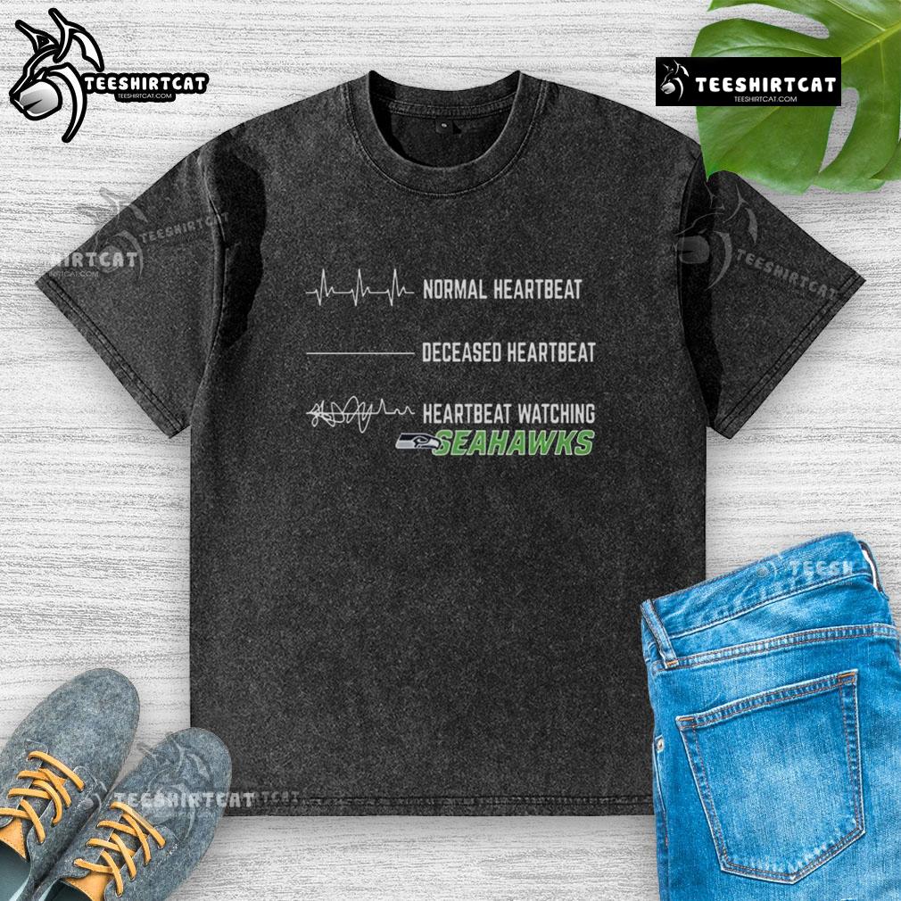 Funny Heartbeat Watching Seattle Seahawks Washed T Shirt Funny heartbeat graphic on a Seattle Seahawks washed t-shirt, perfect for fans showing team spirit in style.