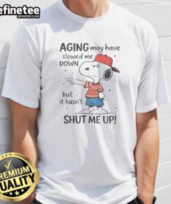 Funny Snoopy Aging May Have Slowed Me Down But It Hasn'T Shut Me Up T-Shirt featuring a playful Snoopy graphic.