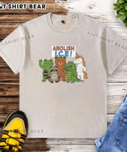 Protest t-shirt featuring a frog, unicorn, raccoon, bear, and dinosaur with 'Good Abolish ICE' slogan in vibrant colors.