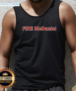 Mike McDaniel wearing a stylish 'Good Fire' tank top, showcasing his trendy sports fashion and vibrant personality.
