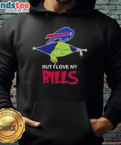 Cheerful fan wearing a Buffalo Bills football hoodie with Grinch design, showcasing team spirit and holiday fun.