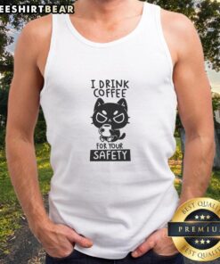 Woman wearing 'Good I Drink Coffee For Your Safety' tank top, enjoying coffee in a cozy caf setting.